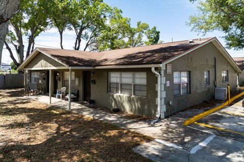 A small house with a brown roof and a yellow line in front.