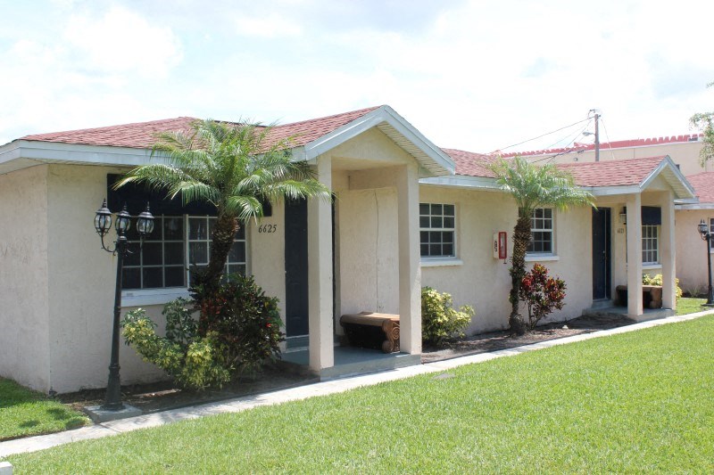 a house with palm trees in front of it