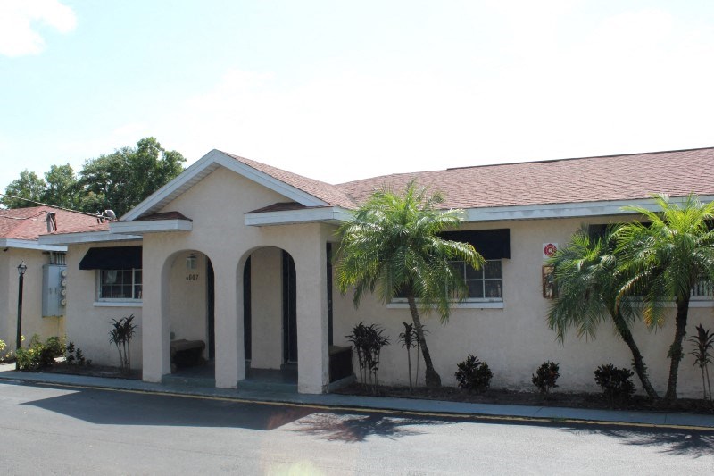 a house with palm trees in front of it