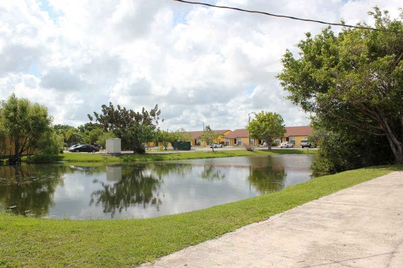 a body of water with a sidewalk next to it