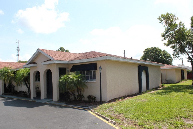a house with palm trees in front of it