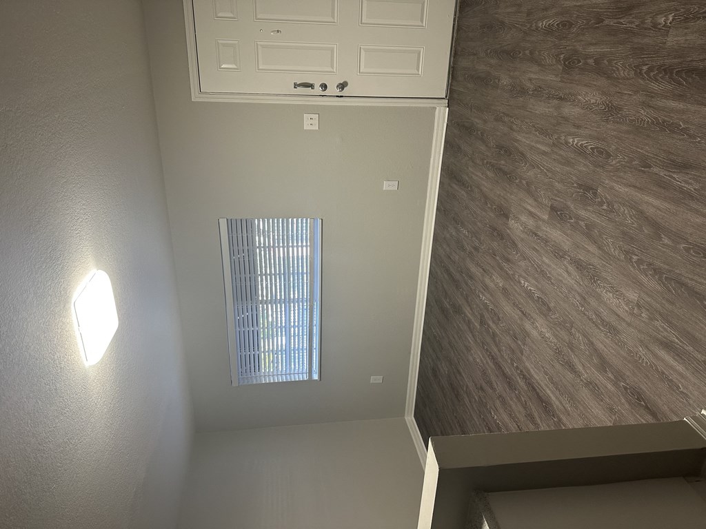 an overhead view of a hallway with a door and a window