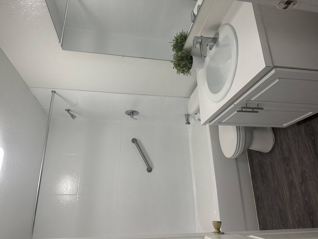a small bathroom with a sink and a shower