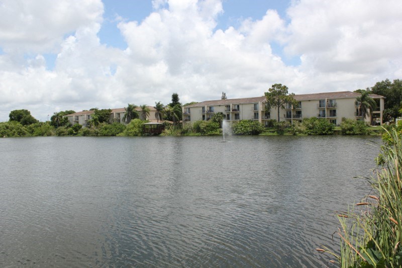 the apartments are overlooking a lake with a fountain