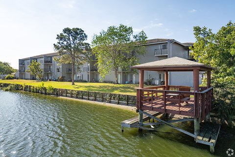 A house with a deck overlooking a body of water.