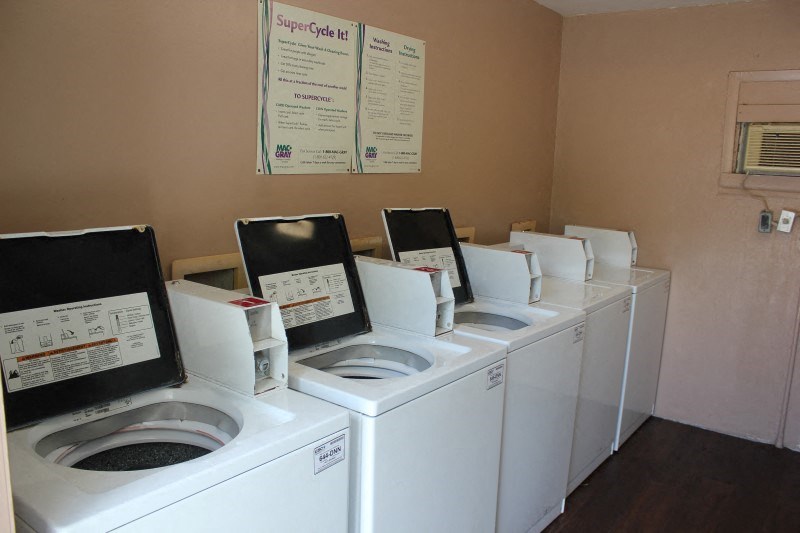 a row of washing machines in a laundromat