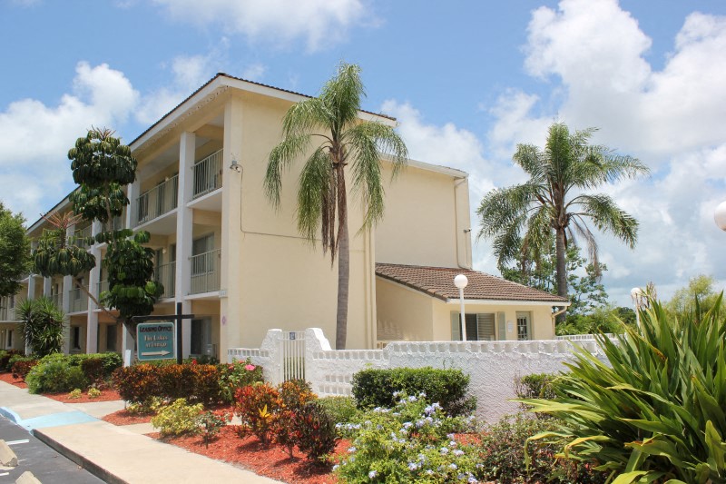 a building with palm trees in front of it