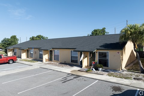A building with a parking lot in front of it.