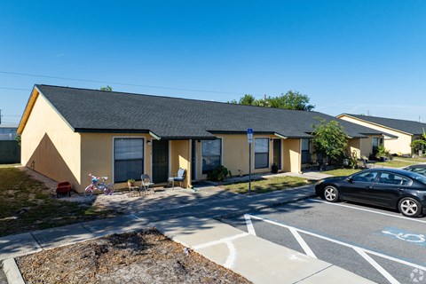 A small building with a car parked in front.