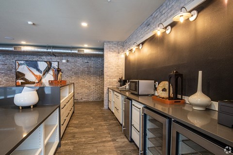 a kitchen with stainless steel counter tops and a exposed brick wall