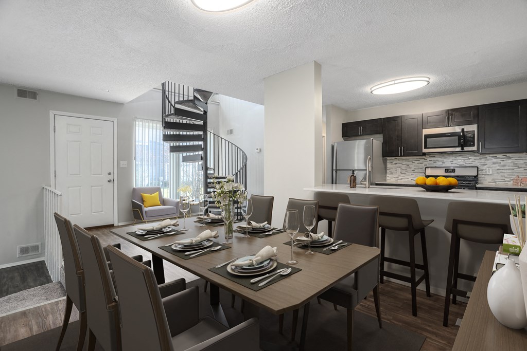 an open kitchen and dining room with a table and chairs