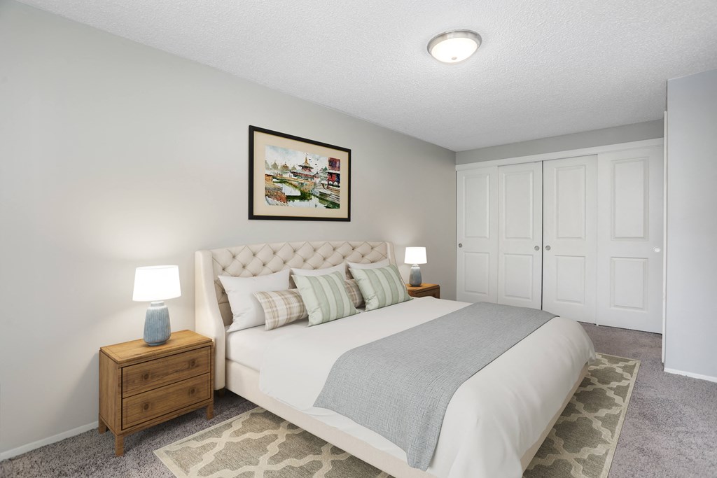 a bedroom with a bed and two night stands