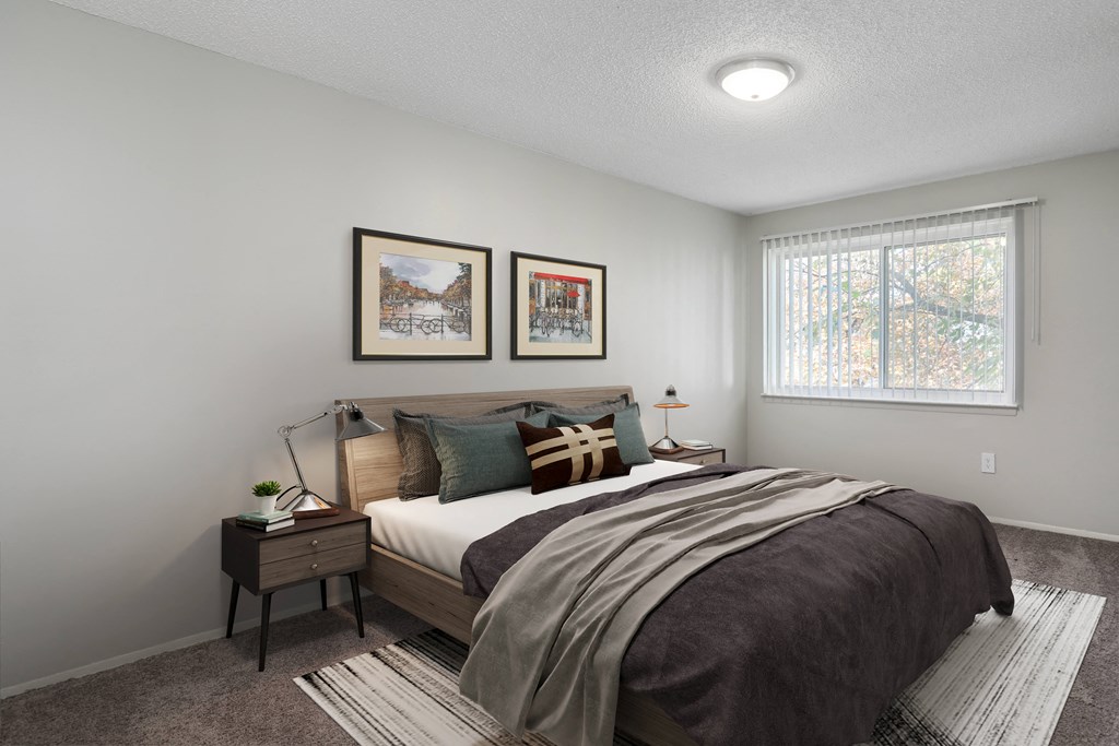 an empty bedroom with a bed and a window