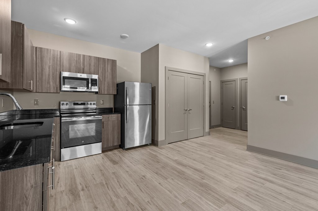A modern kitchen with wooden cabinets and stainless steel appliances.