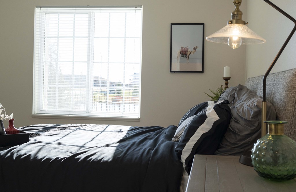 Bedroom with queen size bed and large window