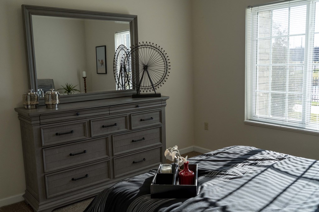 Bedroom with queen size bed, large window, and wardrobe