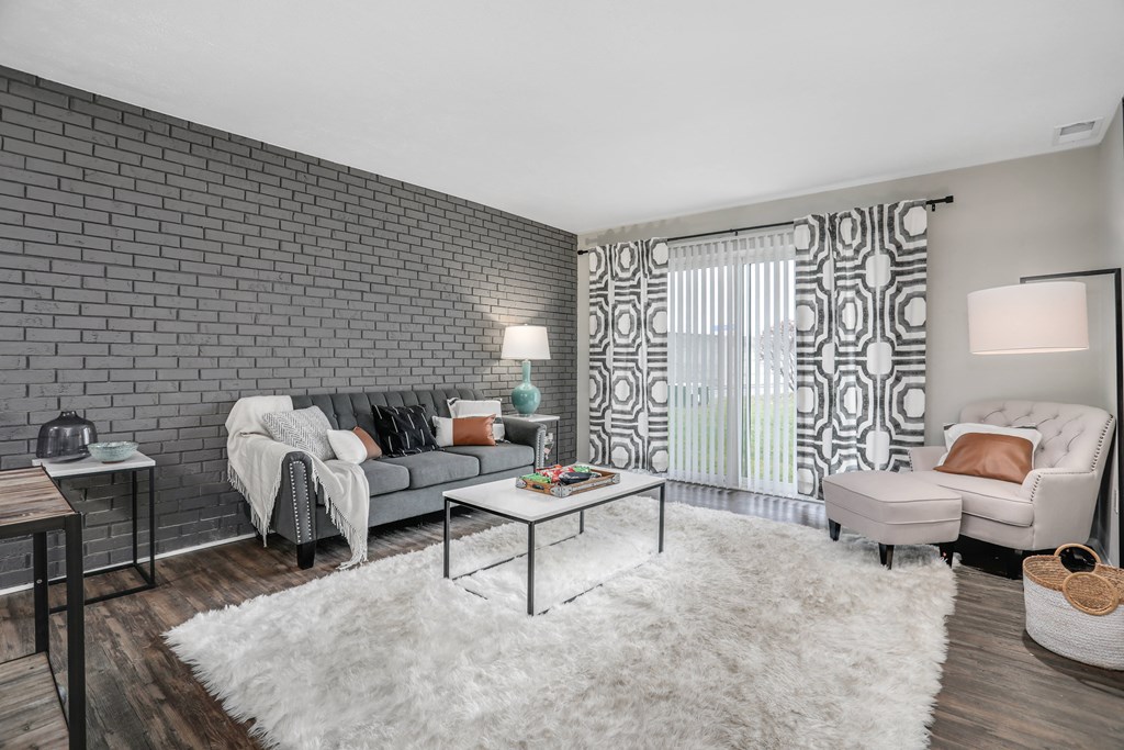 a living room with a couch and a chair and a coffee table