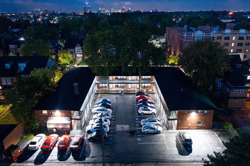 an aerial view of a building with cars parked in a parking lot