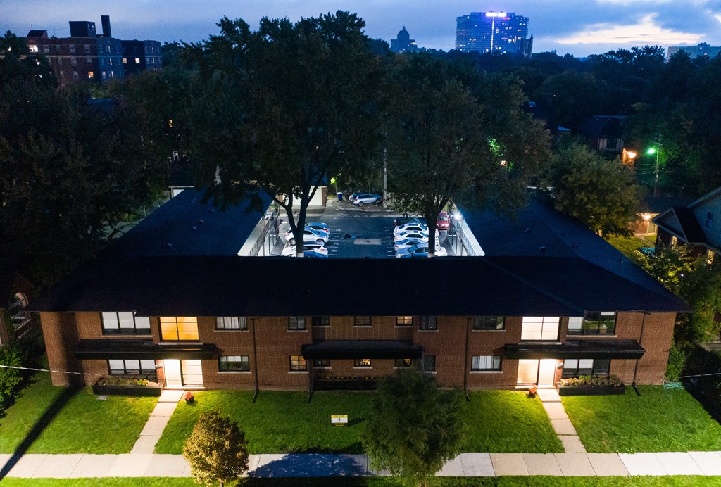 an aerial view of a building with a pool at night