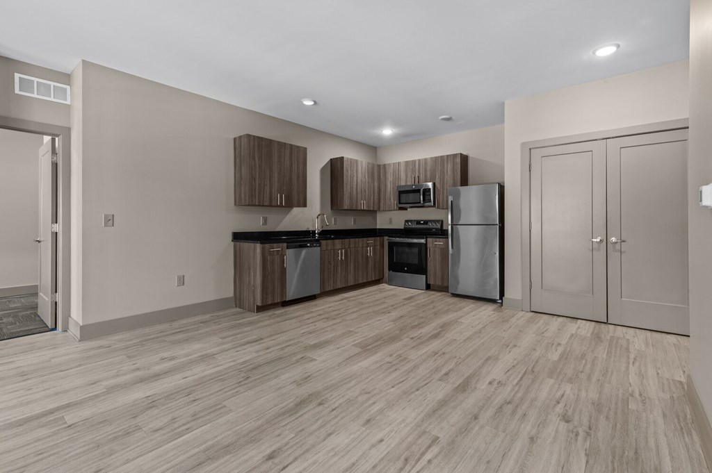 A kitchen with wooden floors and stainless steel appliances.