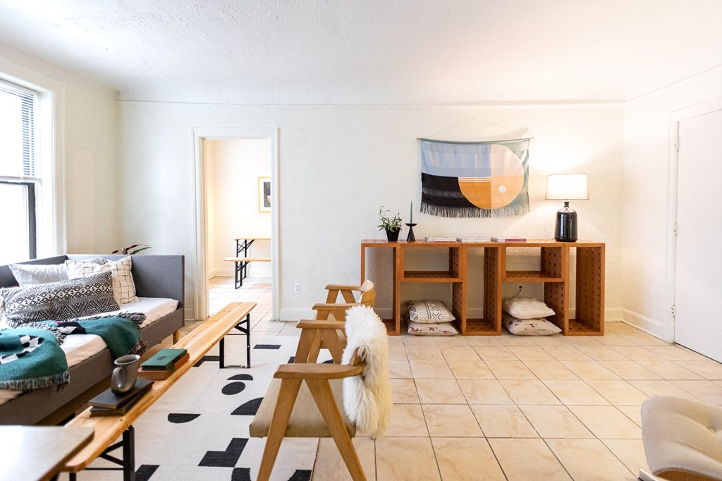living room with white walls and chairs