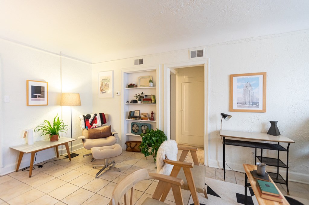 a living room with a couch and chairs and a table