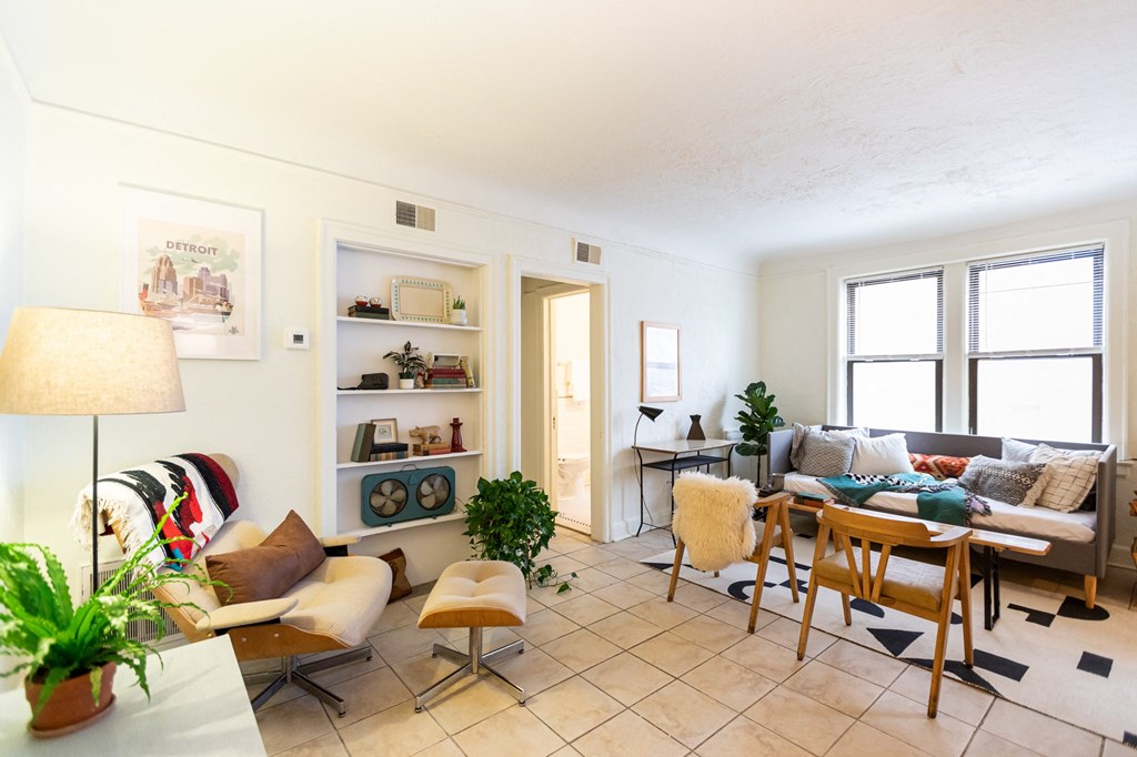 a living room and dining room with a table and chairs