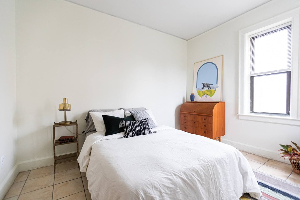 a bedroom with a bed and a ceiling with feathers on it