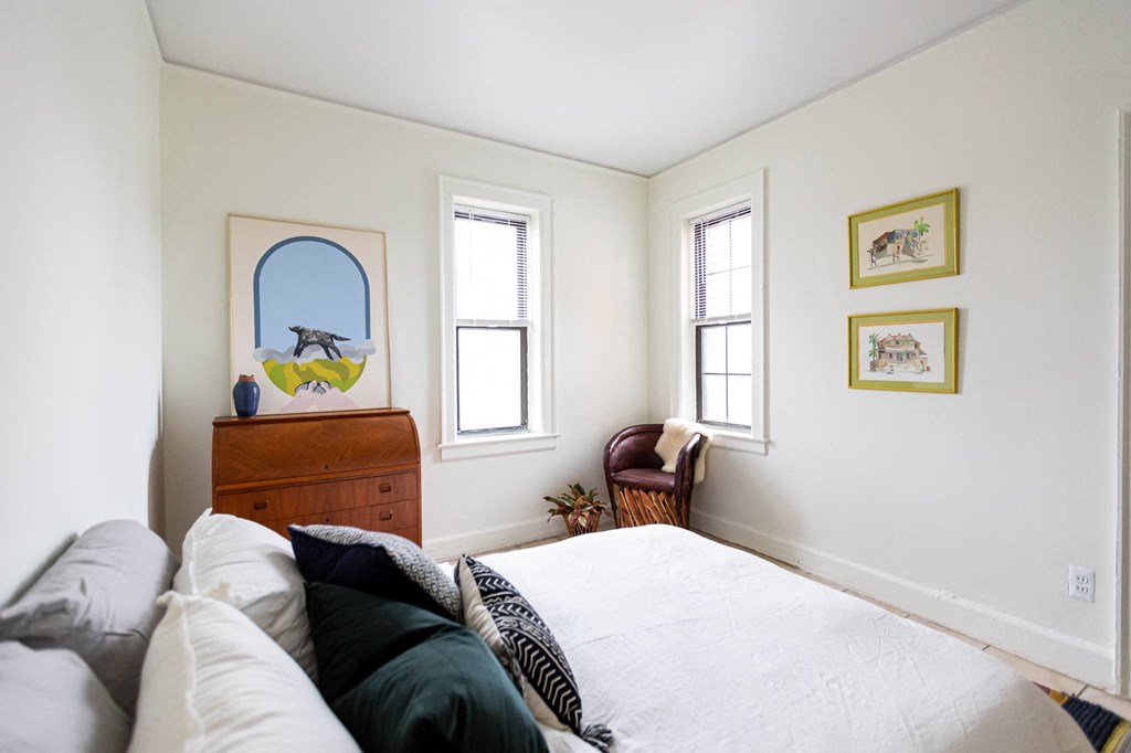 bedroom with white walls and windows