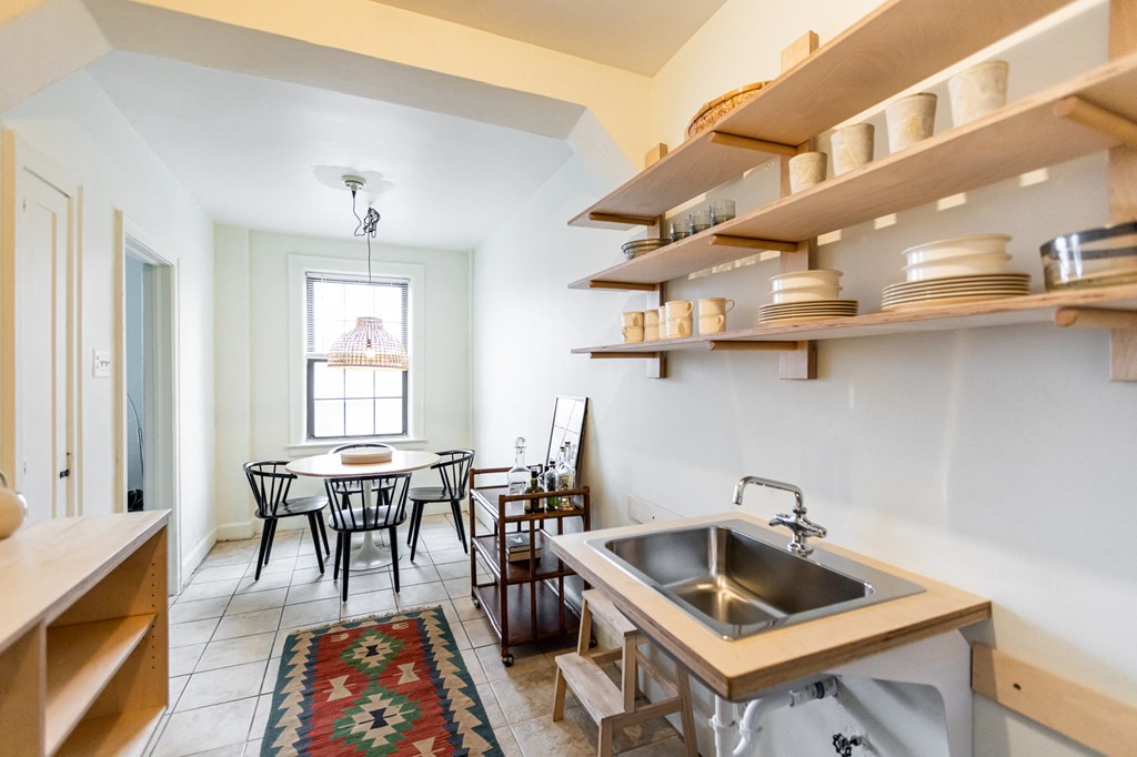 kitchen with white walls and table and chairs