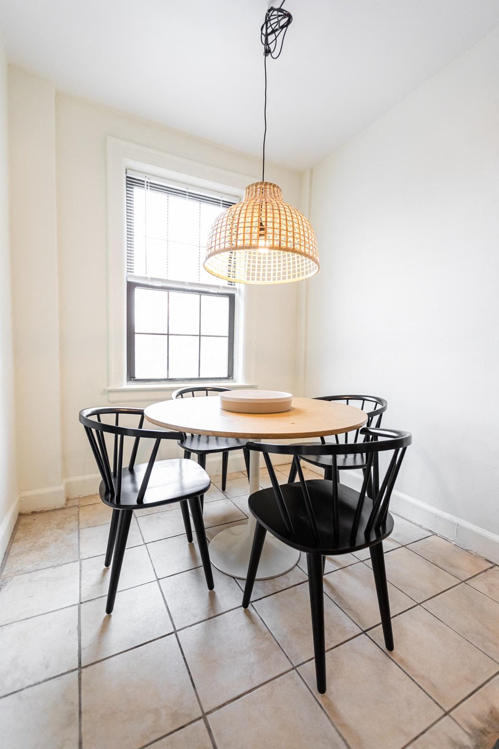 a dining room with a table and chairs and a lamp