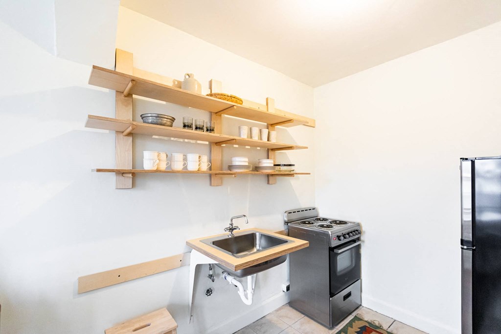 kitchen with white walls and tan shelves