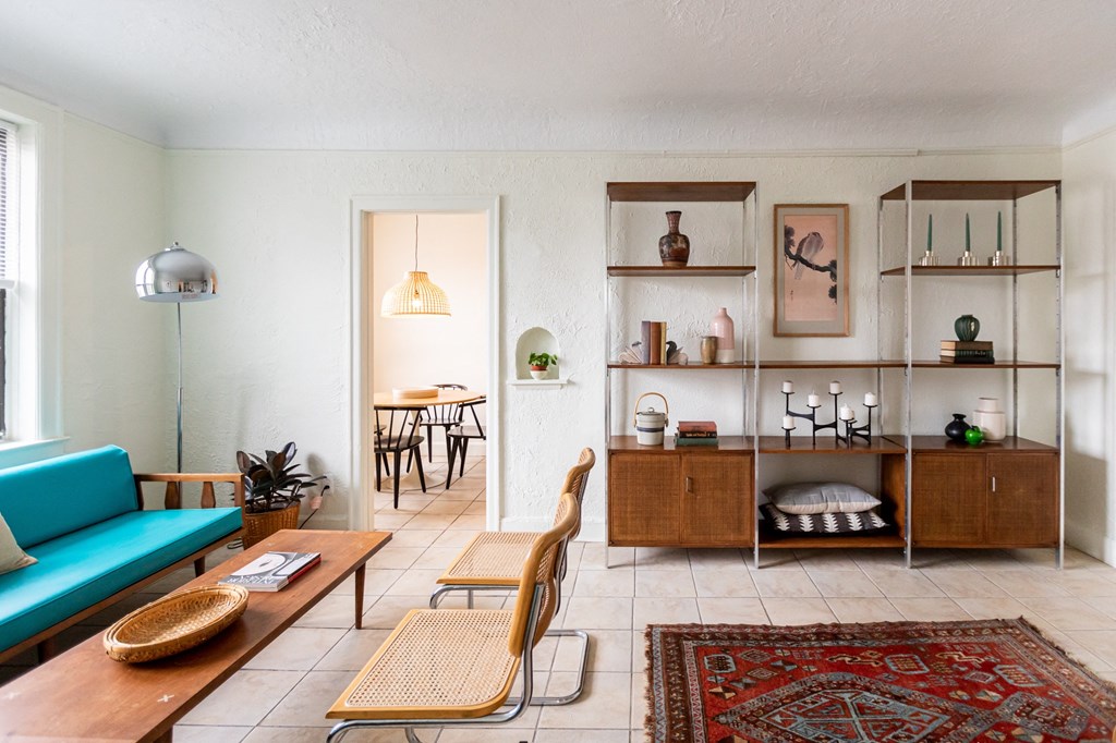 a living room with a blue couch and a wooden table
