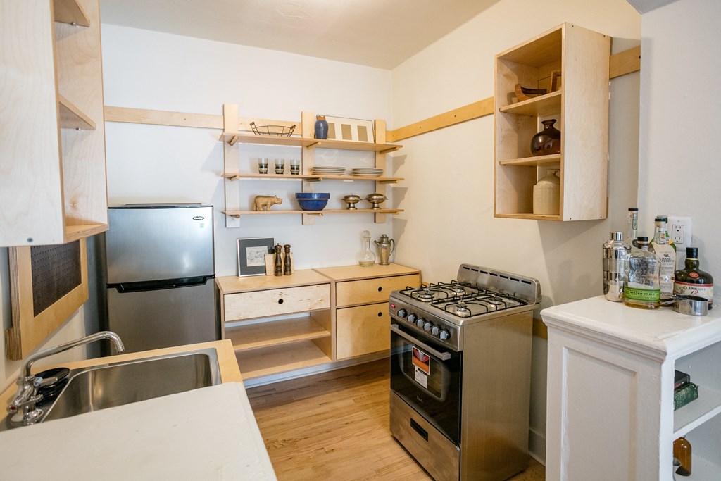 a kitchen with stainless steel appliances and wooden cabinets