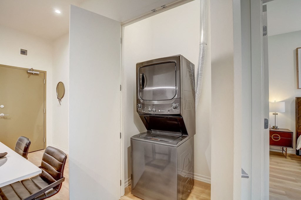 a living room with a television and a refrigerator in a wall
