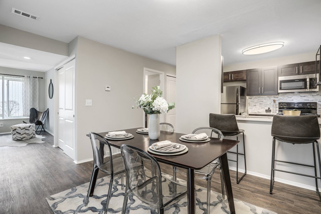 a dining room with a table and chairs and a kitchen