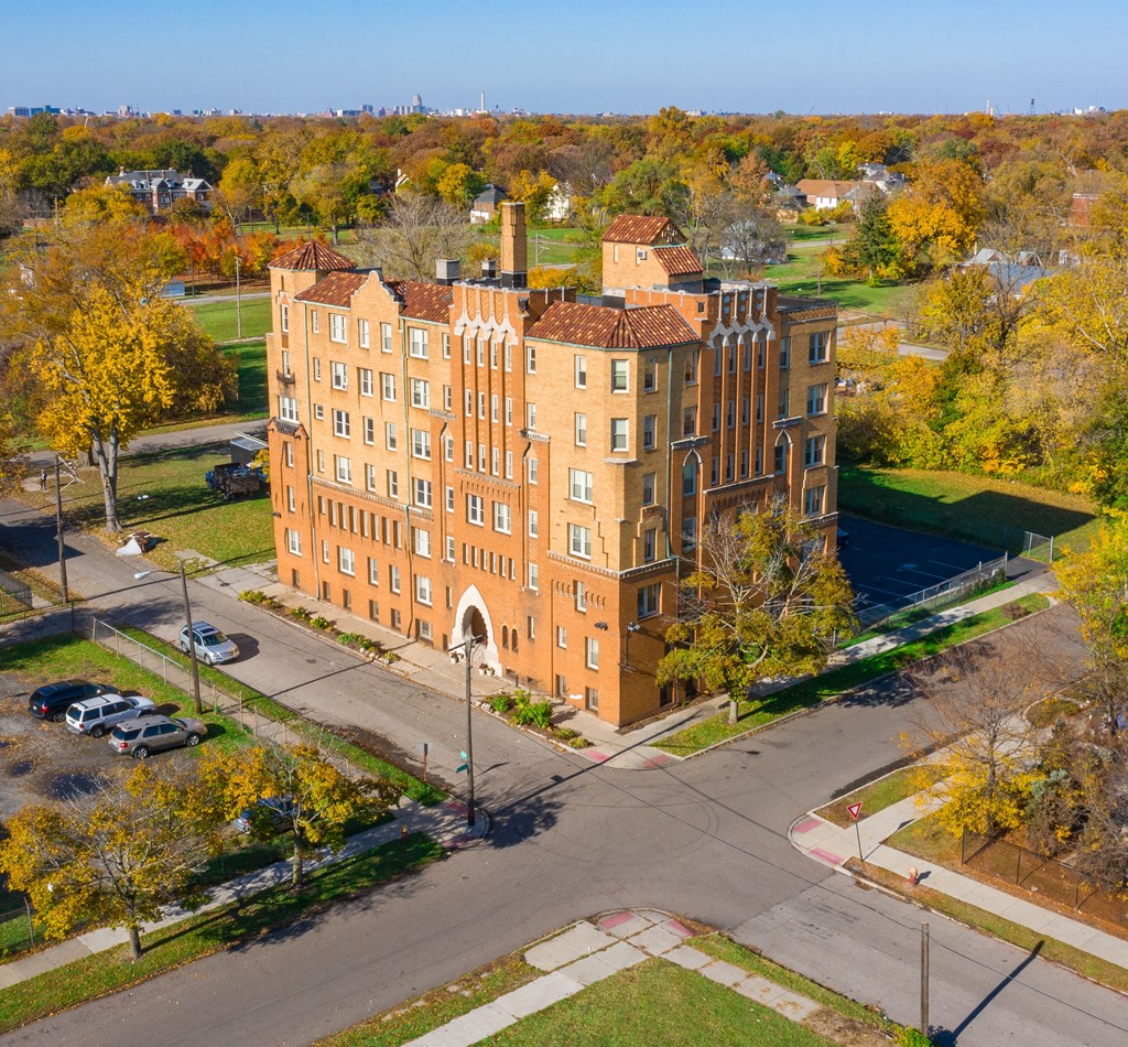 an aerial view of a large brick building on a city street