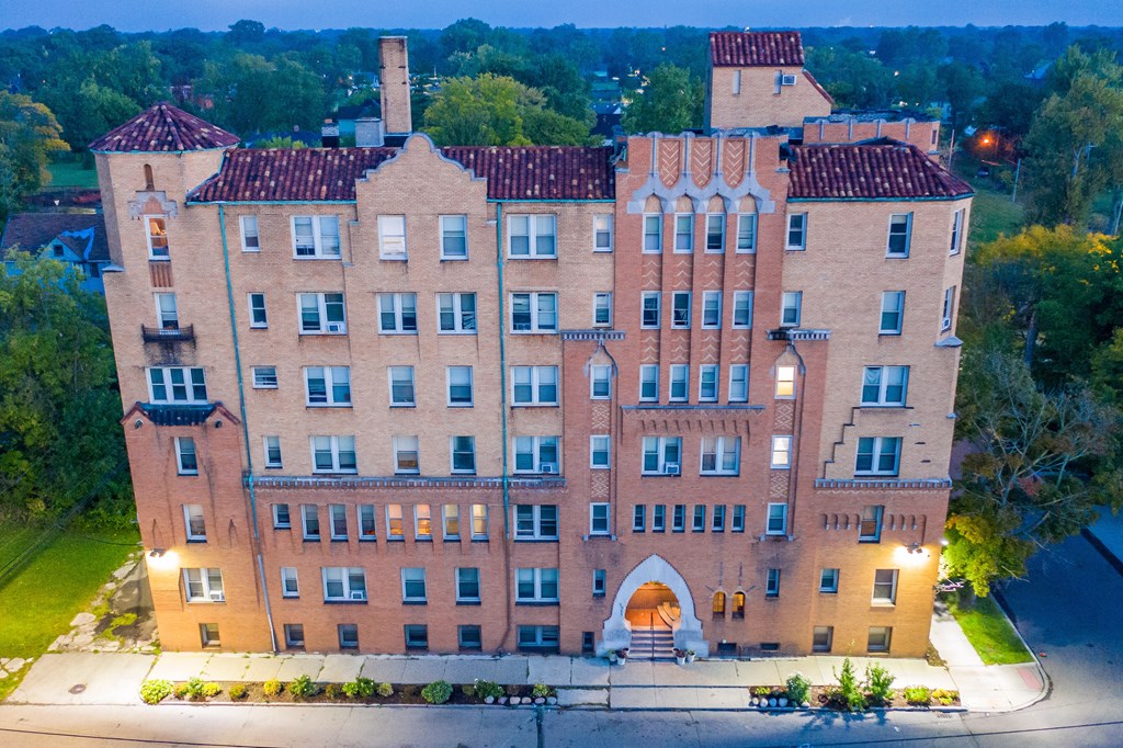 an aerial view of a large brick building at night