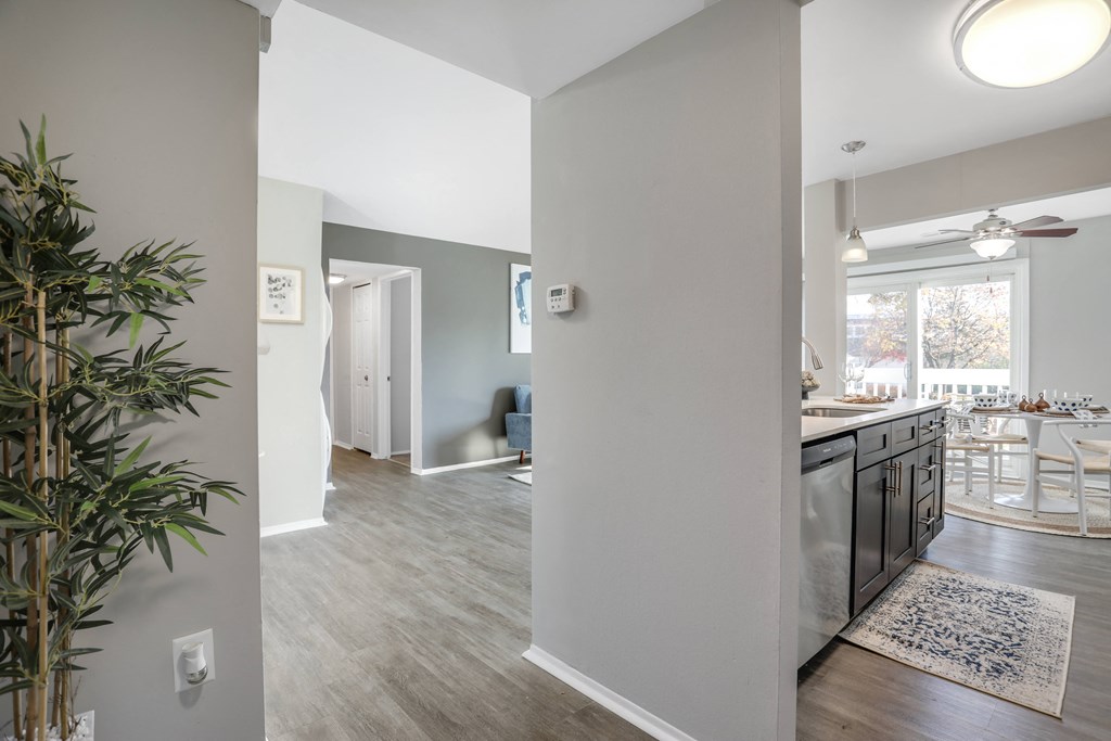 an open kitchen and living room with a view of a dining room and a table