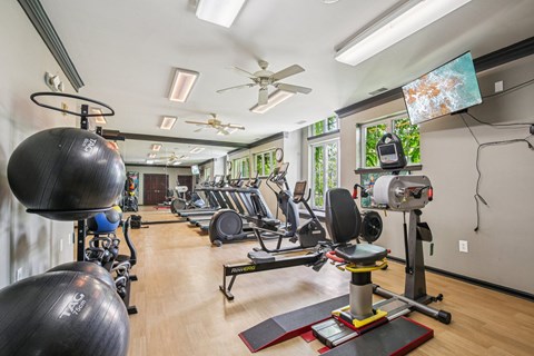 Fitness center with cardio and strength training equipment at Regents Club of Troy Apartments, Troy, 48084