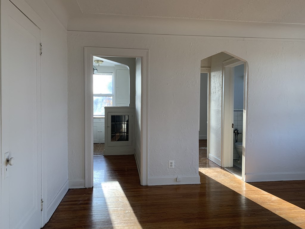 a living room with wood floors and a fireplace