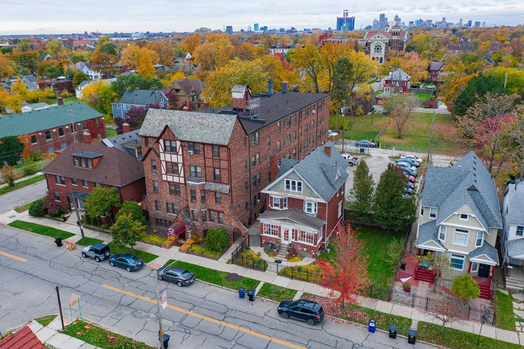 an aerial view of a brick building on a city street