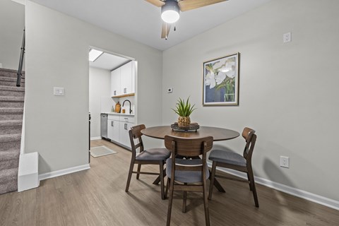 A dining room with a table and chairs.