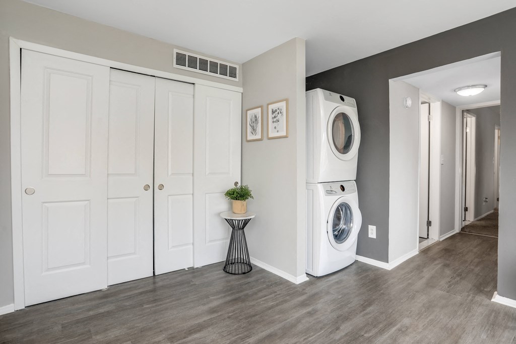 a washer and dryer in a living room with white doors