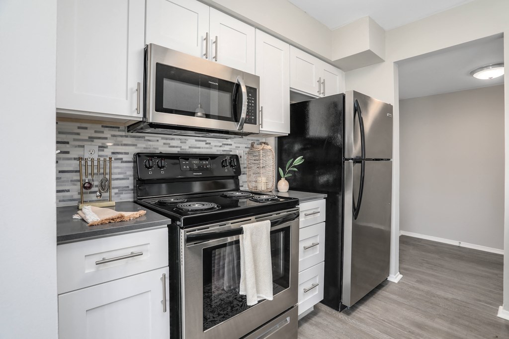 a kitchen with stainless steel appliances and white cabinets