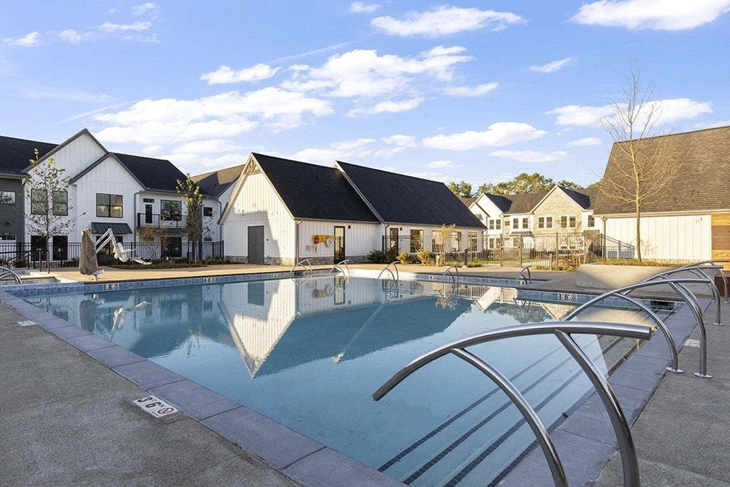 a swimming pool with houses in the background