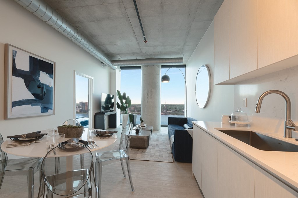 a kitchen and dining area with a table and chairs