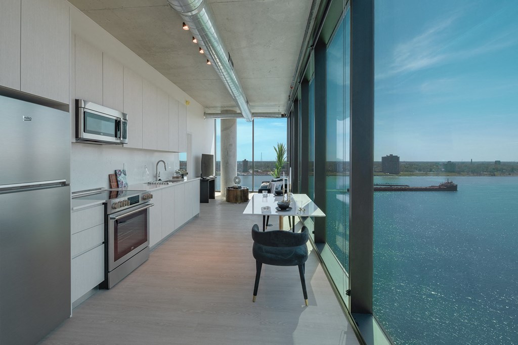 a kitchen and dining room with a view of the water