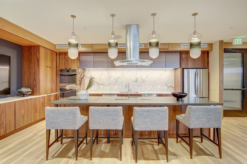 a large kitchen with an island and four chairs