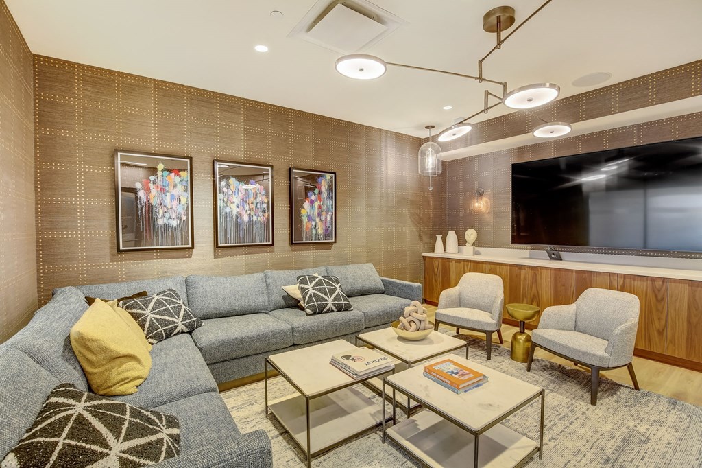 a living room with couches and chairs and a television